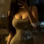KL China Escort Amy taking a mirror selfie in a fitted dress